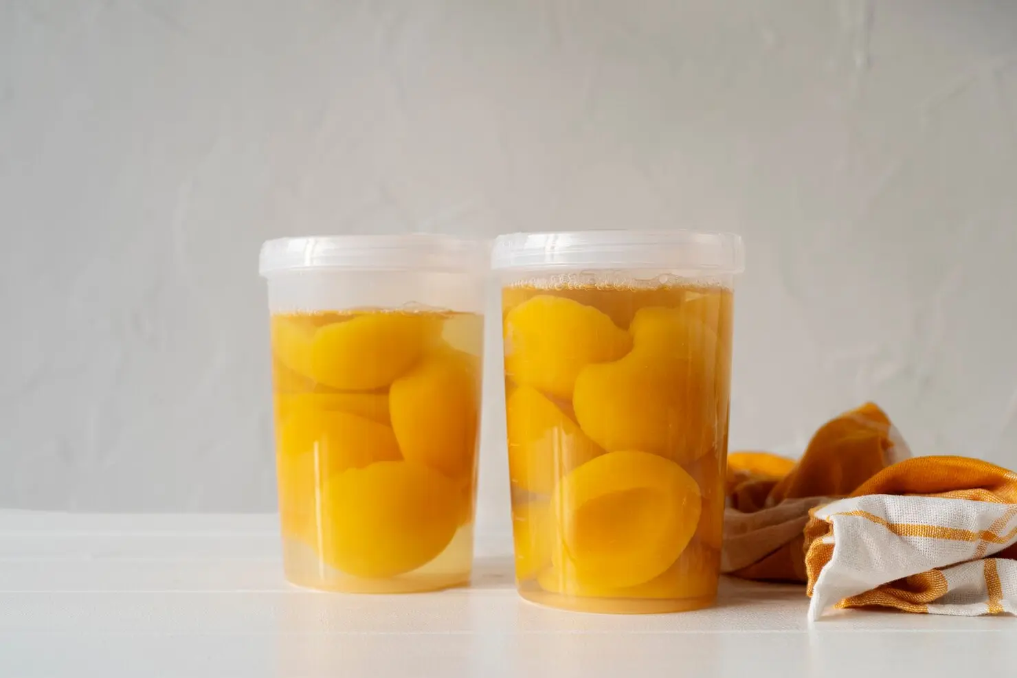 Clear plastic deli containers filled with fruit, demonstrating food-grade packaging for deli and food service.